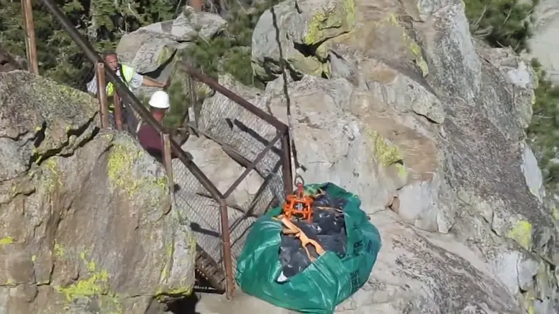 Alliance crew staging bagged asbestos waste for helicopter lift at Needles Lookout